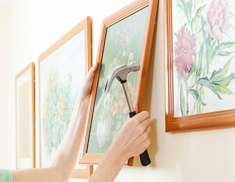 hanging portraits on wall